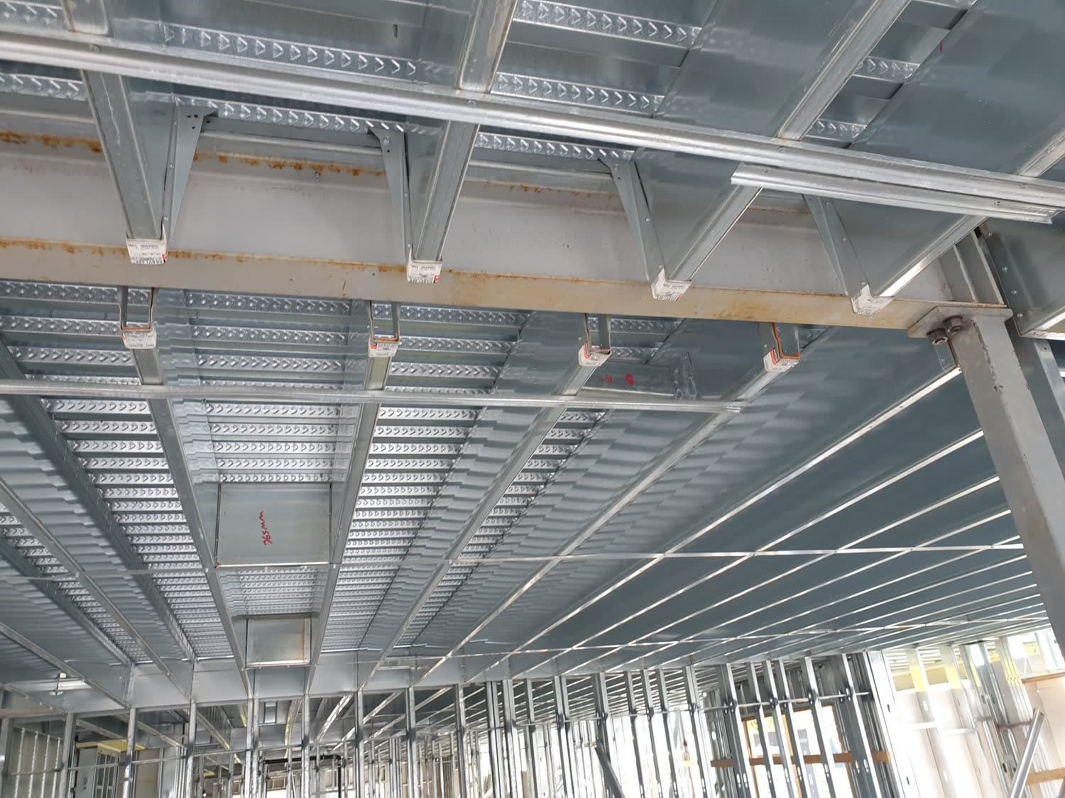 Light-gauge steel and structural framing under construction on a mid-rise building site in Greater Vancouver.