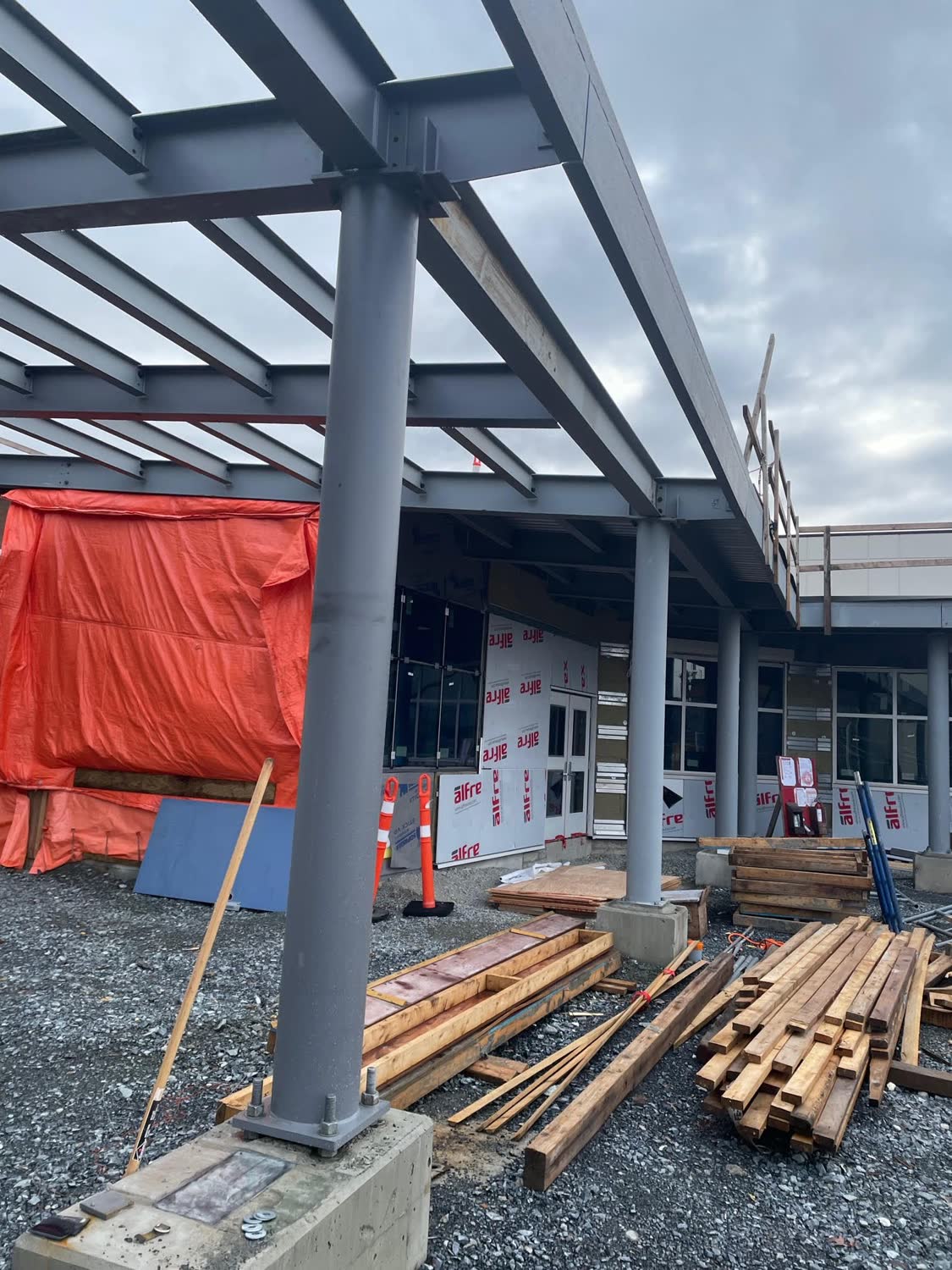 Structural steel frame with steel columns on concrete piers at a commercial building under construction
