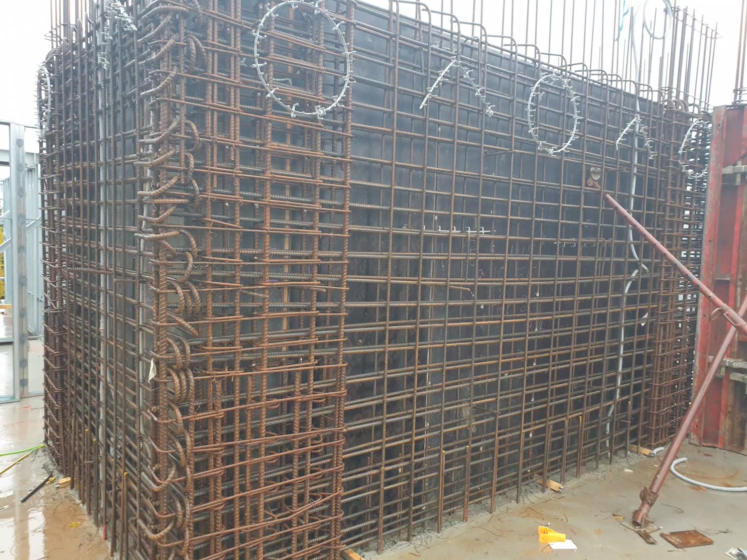 Rebar cage reinforcement for a reinforced concrete shear wall before pour